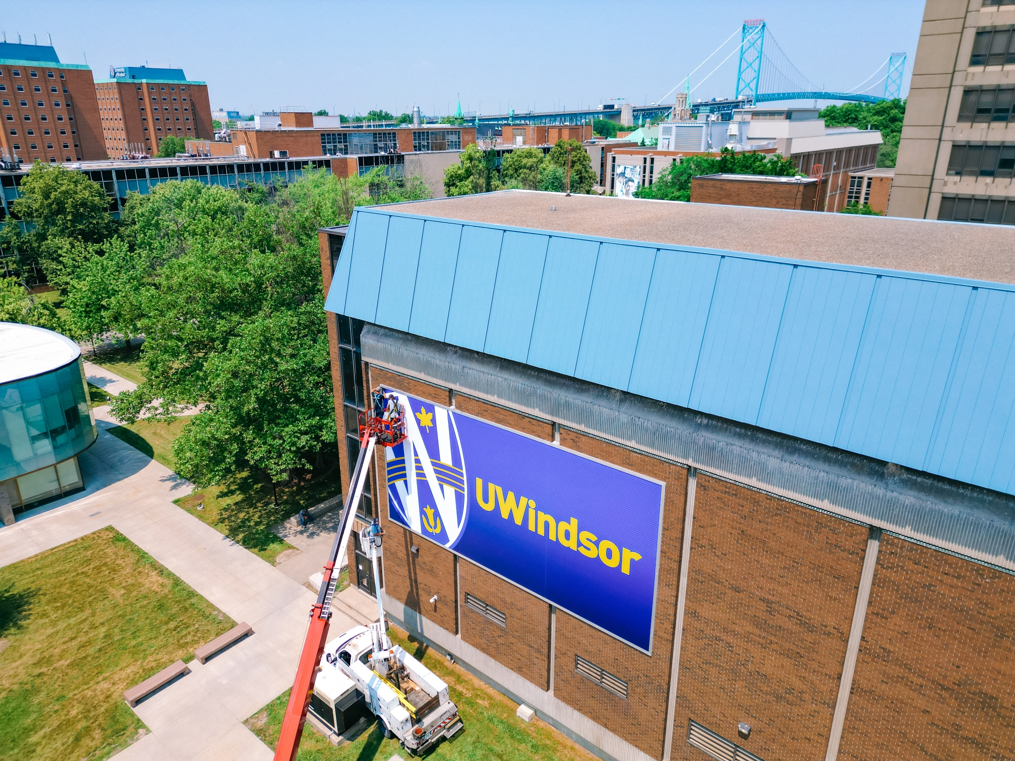 Adding bright blue UWindsor sign on campus building