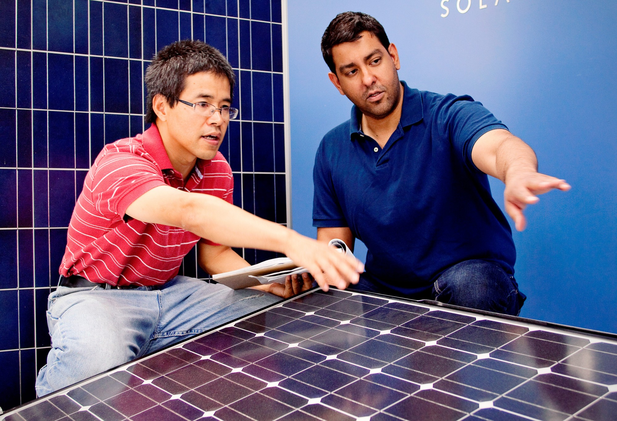 Engineering students discussing on solar panels.
