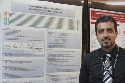 Mo Karimi beside his poster.