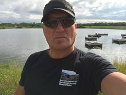 Dr. C. Weisener standing in front of a lake