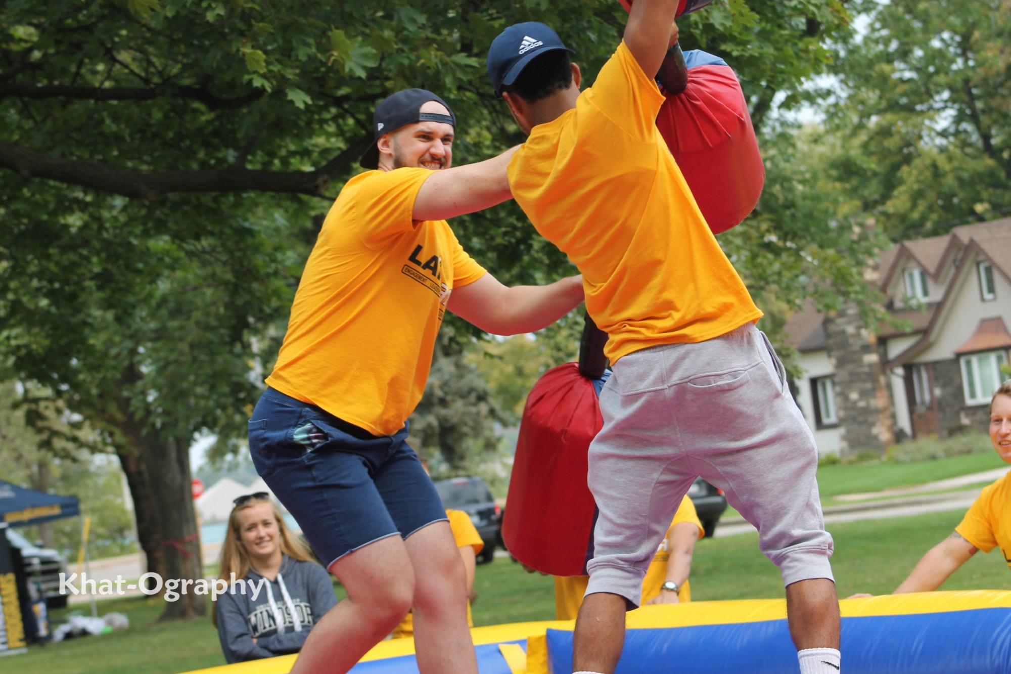 Two students battle with foam sticks at Welcome Week.