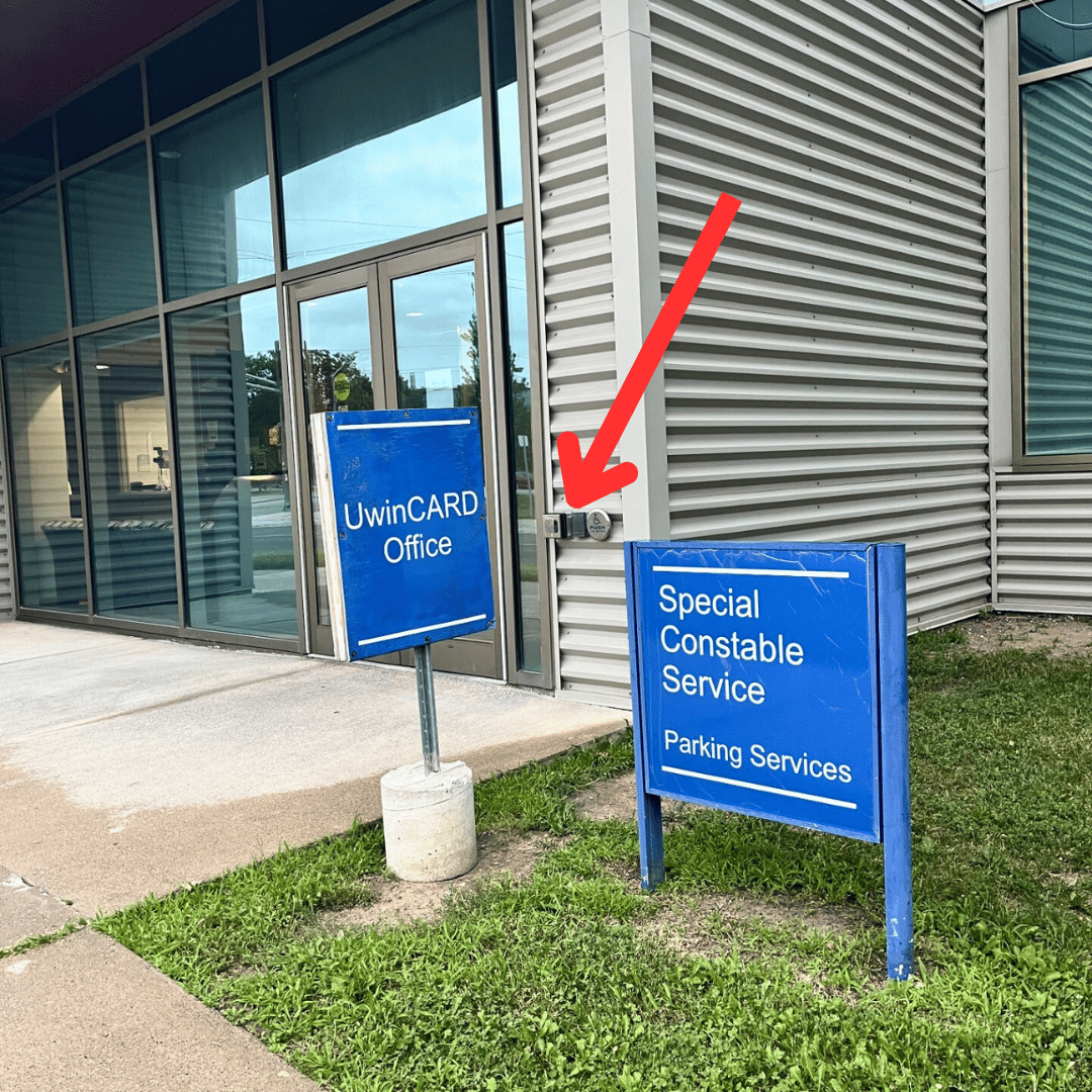 The main doors of the Special Constable Service office with a red arrow pointing to the external speaker box.