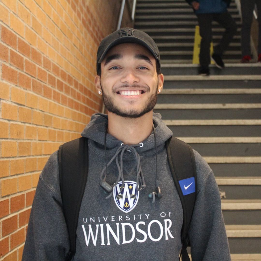 A student wearing a grey University of Windsor sweater
