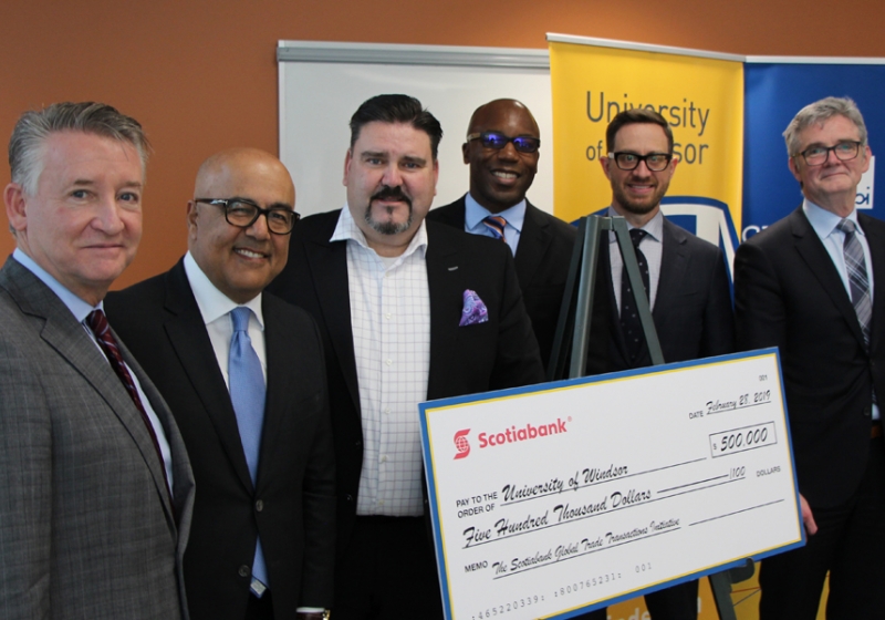 UWindsor interim president Douglas Kneale and Cross-Border Institute director Bill Anderson flank Scotiabank officials Alex Besharat, senior vice-president and head of Canadian wealth management; Terry Roman, director and market lead of commercial banking; Charles Achampong, director of academic partnership engagement and sponsorship philanthropy; and Sean White, ScotiaMcLeod branch manager, director and wealth advisor.