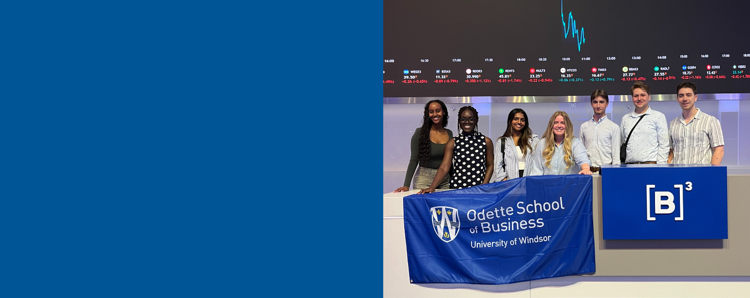 Students pose at B3 stock exchange with Odette School of Business flag