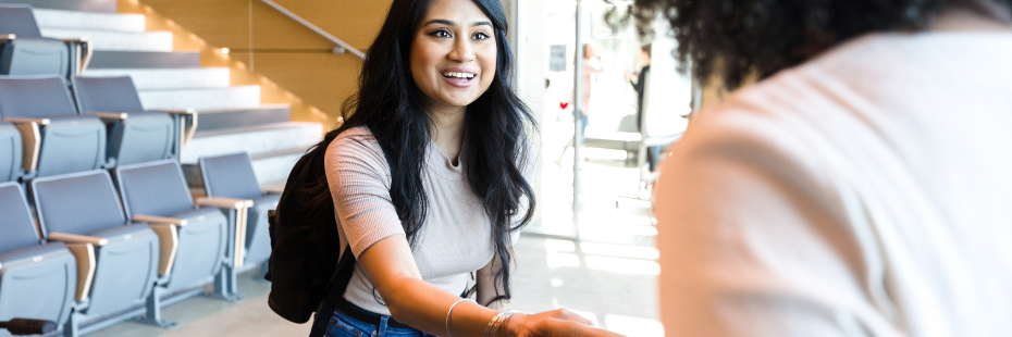 student shaking hand with employer at job fair