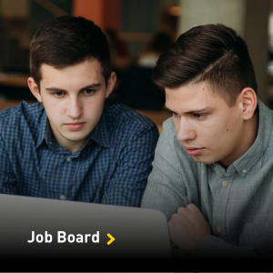 Two male students looking at a computer screen.