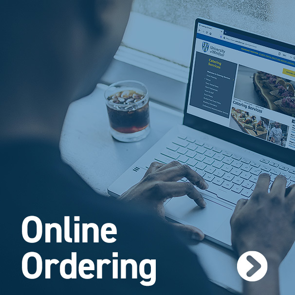 Over the shoulder angle of a user on laptop setting up a catering order