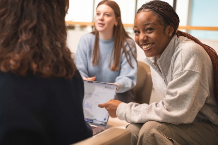 three female students in discussion