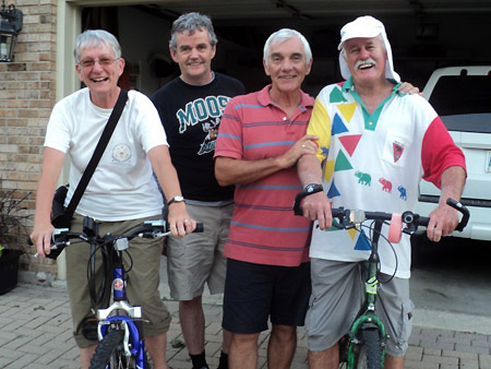 Patsy and Alan Paxton sit on bikes while posed with Leo Groarke and Alan Wright.