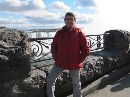 Sue Purnell stands in front of Niagara Falls