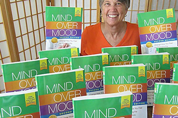 Author Christine A. Padesky with copies of the second edition of “Mind Over Mood.”