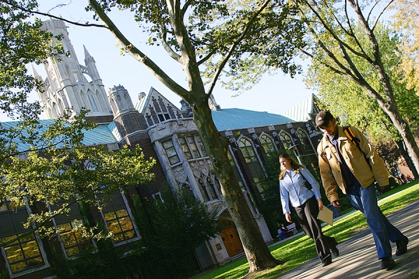 students walking past Dillon Hall