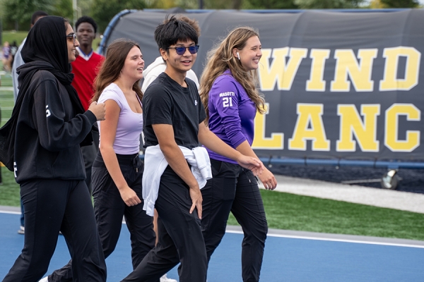 high schoolers walk track