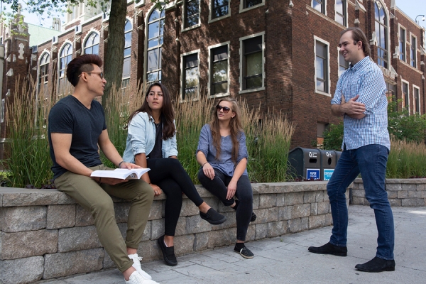 students in conversation outside Dillon Hall