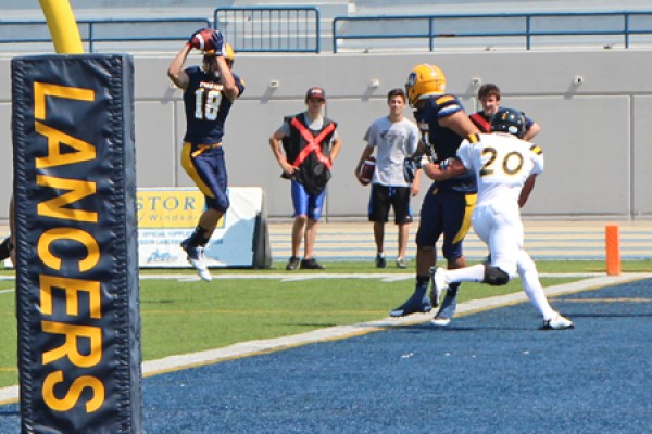 Receiver Evan Pszczonak hauls down a touchdown pass.