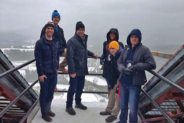 Students pose atop ski jump.