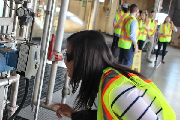 Computer science student Tong Li gets a close look at a gauge in the Hiram Walker and Sons distillery.