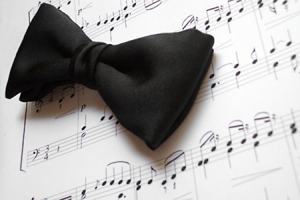 black tie on top of sheet music