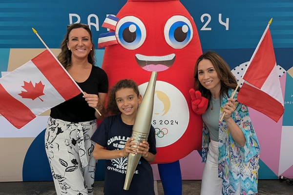 Emmanuelle Richez poses with her friend Marie-Ève Soumis, goddaughter Camélia Jean-François, and Olympic mascot Phryge.