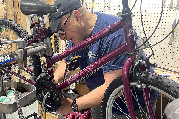 Robert Aguirre working on bike