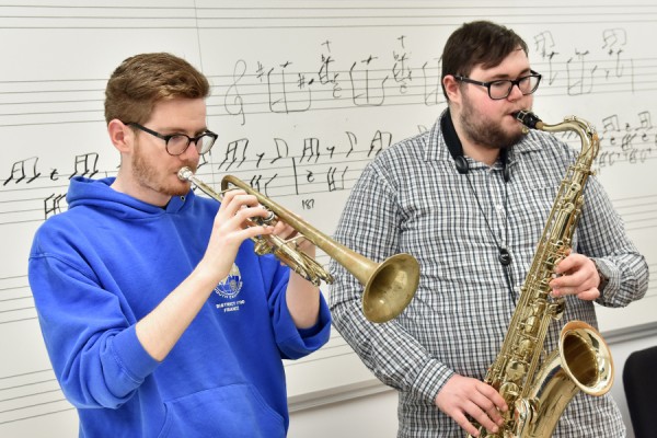 students playing trumpet and saxophone