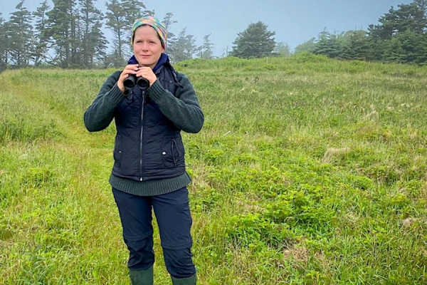 Sarah Dobney holding binoculars