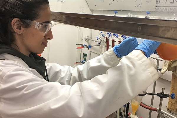 Joy Kobti reaching under shelf in lab