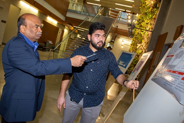 Dr. Bolisetti judging student poster