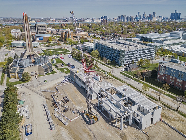 crane lifting concrete slabs on construction site