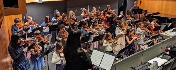 young students performing on stringed instruments