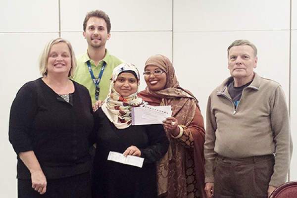 Sameena Sultana (centre) accepts congratulations from Patti Lauzon of the alumni office and OPUS officials Steve Jancev, Maryan Amalow and Edward King