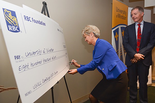 Francine Dyksterhuis signing a big cheque