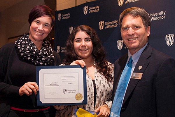 Leila White receives congratulations from dean of students Clayton Smith and Lynn Charron