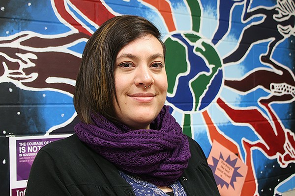 Amelia Runchey of the Womyn’s Centre models one of the purple scarves it is selling to benefit Hiatus House.