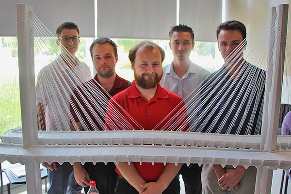 Engineering students George Vereyken, Matthew Lemmon, Cameron McDonald, Nathan Barbarossa and Joshua Haddad display their award-winning design for the Gordie Howe International Bridge.