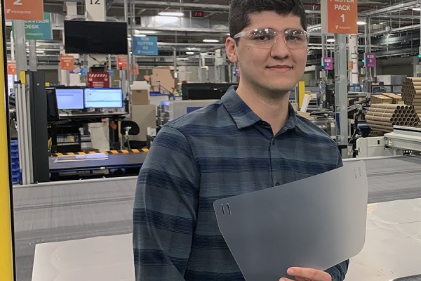 Bogdan Gramisteanu holding a face shield insert.