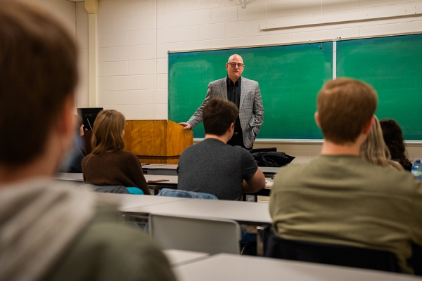 Drew Dilkens standing in front of classroom