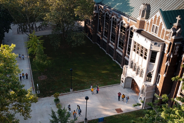 People standing in groups outside Dillon Hall