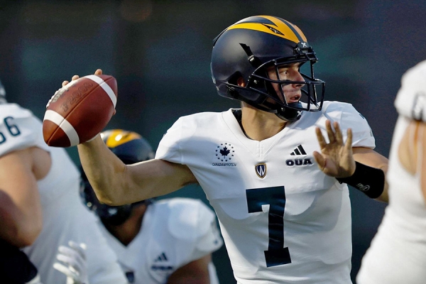 Quarterback Danny Skelton pulls football back to throw a pass.