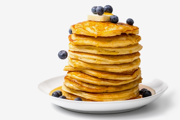 stack of pancakes with blueberries and syrup