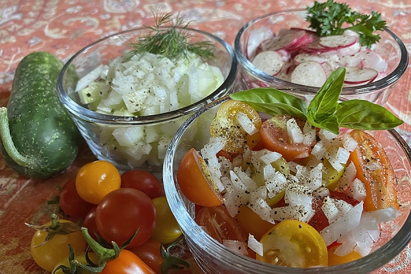 bowls of tomato, cucumber, and radish salads