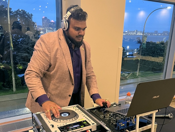 R.J. Sivanesan wearing headphones behind deejay turntables