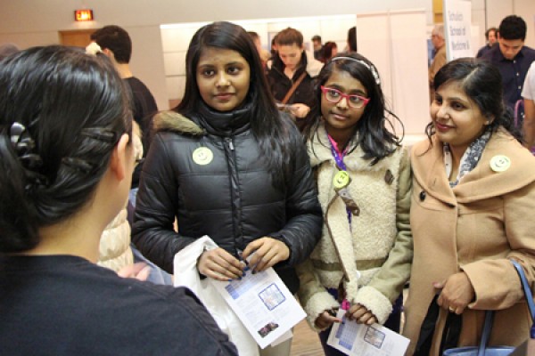 Belinda Joseph and members of her family speak with a representative of the Faculty of Science