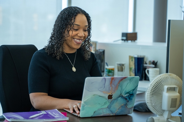 Jasmine Knight smiling seated at computer