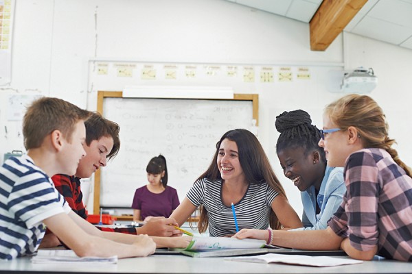 students gathered around table