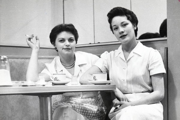 two women sitting at table