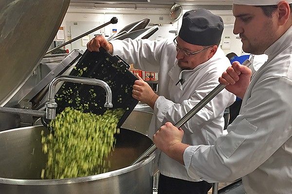 Chefs Peter Polak and Thomas Ascott prepare a large pot of chili for today’s charity lunch.