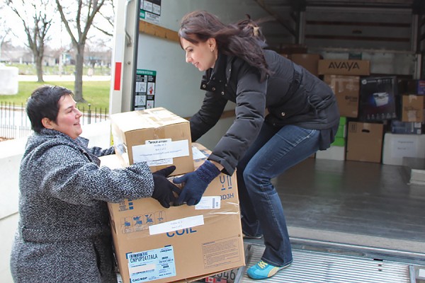 Pat Simone hands a package to Sabina Howell.