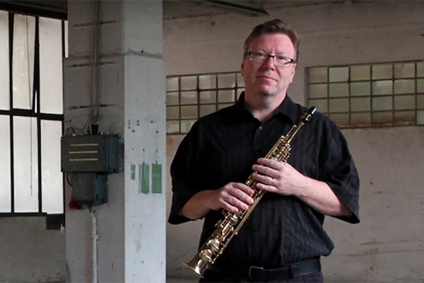 Brent Lee holding soprano saxophone